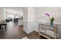 Elegant entryway with wood floors, decorative molding, and a mirrored accent table with an orchid at 4312 Plumeria Way, Fort Mill, SC 29707