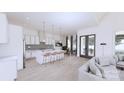 Contemporary kitchen with island seating, pendant lights, and stainless steel appliances at 4609 Firethorn Ct, Denver, NC 28037