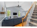 Open-concept living space with hardwood floors, vaulted ceilings, and stairway to second floor at 4927 Gateway Dr, Claremont, NC 28610