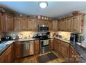Functional kitchen with wood cabinets, stainless steel appliances, and hardwood flooring at 506 E Pine St, Maiden, NC 28650