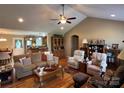Inviting living room featuring a ceiling fan, hardwood floors, and vaulted ceiling at 506 E Pine St, Maiden, NC 28650