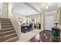Elegant dining room with dark wood table, chandelier, and decoratively patterned rug at 6041 Laurent Ave, Fort Mill, SC 29715