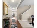 Hallway with hardwood floors, carpet, a staircase, and decorative accents. Ready to welcome you home at 6041 Laurent Ave, Fort Mill, SC 29715