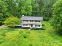Picturesque aerial view of the home surrounded by lush greenery, offering privacy and a serene setting at 7531 Linda Lake Dr, Charlotte, NC 28215