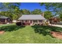 Lovely single-story home with a groomed lawn, inviting front porch, and beautiful landscaping at 806 Mcgregor Ne Dr, Concord, NC 28025