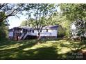 Charming home features a spacious backyard, screened porch, and deck perfect for outdoor relaxation at 854 Silver Fox Dr, Concord, NC 28025