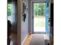 Charming entryway with a blue door, hardwood floors, and convenient coat hooks at 854 Silver Fox Dr, Concord, NC 28025