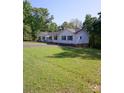 Beautiful ranch home with an expansive green lawn, mature trees, and a well-maintained exterior at 854 Silver Fox Dr, Concord, NC 28025