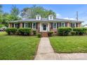 Charming brick home with well-manicured lawn and shrubbery, featuring dormer windows and a welcoming walkway at 101 Wynnchester Rd, Gastonia, NC 28056