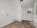 Clean laundry room with tile floors, window, and laundry hookups installed at 102 Erwin St, Chester, SC 29706