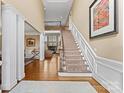 Grand foyer with hardwood floors, staircase, and fireplace visible in the background at 107 Waterhouse Ct, Mooresville, NC 28117