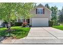 Two-story home with neat front yard, well-manicured shrubbery, and a charming red door at 1218 Faversham Ln, Rock Hill, SC 29730