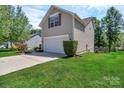 Two-story home showcasing a well-kept lawn and a two-car garage at 1218 Faversham Ln, Rock Hill, SC 29730