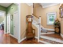 Welcoming foyer features hardwood floors, a decorative coat rack, and a staircase with natural light at 136 Water Oak Dr, Mooresville, NC 28117
