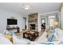 Comfortable living room features a stone fireplace, neutral colors, and an open layout perfect for relaxation at 18020 Owl Ct, Indian Land, SC 29707