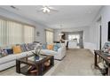 Bright and airy living room featuring plush sofas, a dark wood coffee table, and an open-concept design at 18020 Owl Ct, Indian Land, SC 29707