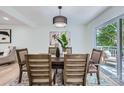 Stylish dining room featuring modern furnishings, a decorative light fixture, and sliding glass doors to the outdoor deck at 200 Kimrod Ln, Charlotte, NC 28270