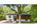 Charming renovated home with a mix of wood and white painted brick exterior and a beautiful front yard at 200 Kimrod Ln, Charlotte, NC 28270