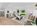 Open-concept living room with neutral color palette, light-colored wood floors, and large windows at 200 Kimrod Ln, Charlotte, NC 28270