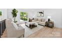 Bright living room with large windows, neutral decor, light wood floors, and stylish seating at 200 Kimrod Ln, Charlotte, NC 28270