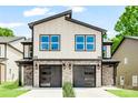 Modern two-story home with stone accents, black framed windows, and two-car garages at 2015 Wilson Ave, Charlotte, NC 28208