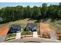 Aerial view of two new construction homes on a tree-lined street with ample lot space at 2567 Cornelius Nw Pl, Concord, NC 28027