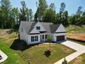 New construction home boasts a pristine lawn and a modern, neutral color palette at 2567 Cornelius Nw Pl, Concord, NC 28027