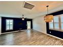 Bright living room featuring sleek floors, modern ceiling fan, shutters and stylish lighting fixture at 3619 Whitney Way, Terrell, NC 28682