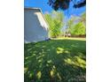 Large, grassy backyard with mature trees, offering a private outdoor space for recreation and relaxation at 400 Antlers Ct, Gastonia, NC 28052