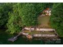 Serene backyard featuring a dock, waterfront access, and lush greenery at 4749 16Th Street Ne Dr, Hickory, NC 28601