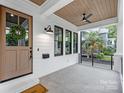 Inviting front porch with stained wood ceiling and black accents, providing a cozy outdoor space at 632 Dorothy Dr, Charlotte, NC 28203
