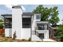 Back exterior view with white brick chimney, two stories, rear porch, stairs and black railings at 632 Dorothy Dr, Charlotte, NC 28203