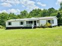 Charming single-story home with a front porch, nestled in a green lawn and wooded area at 645 E Border E Rd, Rock Hill, SC 29730