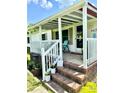 Inviting front porch with brick steps, white railing, and space to relax and enjoy the outdoors at 645 E Border E Rd, Rock Hill, SC 29730