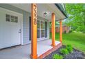 Close up of front porch featuring wood posts and well landscaped flower beds at 7328 Starvalley Dr, Charlotte, NC 28210