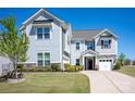Inviting two-story home featuring stone accents, a well-manicured lawn, and a welcoming entrance at 990 Nw Capwalk Nw Rd # 138, Concord, NC 28027
