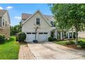 Inviting two-story home with a two car garage, basketball hoop, well-manicured lawn, and a covered porch at 125 N Wendover Trce, Mooresville, NC 28117