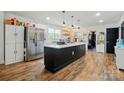 Spacious kitchen features a large island with white countertops, stainless steel appliances, and wood floors at 139 5Th St, Huntersville, NC 28078