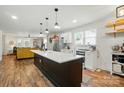 Bright kitchen featuring a center island, stainless steel appliances, and an open floor plan to the living area at 139 5Th St, Huntersville, NC 28078
