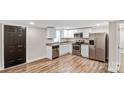 Modern kitchen featuring stainless steel appliances, white cabinets, granite countertops, and wood-look flooring at 143 Phifer Cir, Kings Mountain, NC 28086