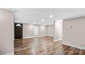 Bright living room featuring stylish wood floors, fresh paint, modern recessed lighting, and a half-light entry door at 143 Phifer Cir, Kings Mountain, NC 28086