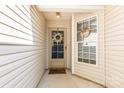 Close-up of the covered front porch, showcasing a decorated front door and a welcoming atmosphere at 228 Grayland Rd, Mooresville, NC 28115