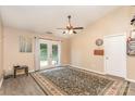 Spacious living room featuring vaulted ceilings, wood-look floors, and French doors leading to the backyard at 228 Grayland Rd, Mooresville, NC 28115