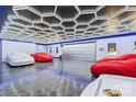Luxury garage showcasing multiple covered cars, a polished floor, and a modern ceiling with geometric lighting at 3009 Brooks Mill Ln, Wingate, NC 28174