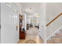 Welcoming foyer with tile flooring, staircase, coat storage, and a view into the open living area at 3030 Priory Ridge Dr, Fort Mill, SC 29707