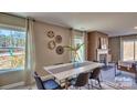 Stylish dining room with fireplace, modern furniture, and ample natural light creates an inviting atmosphere at 3068 Ora Smith Rd, Lincolnton, NC 28092