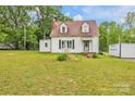 A charming exterior view of the cozy home, featuring a red roof and well-maintained yard at 3101 Hickory Hwy, Statesville, NC 28677