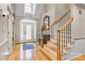 Bright foyer featuring hardwood floors, staircase with iron spindles, and decorative glass door at 3125 Arden Way, Claremont, NC 28610
