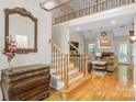 Open-concept living room with hardwood floors, fireplace, and staircase to upper level at 3125 Arden Way, Claremont, NC 28610