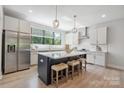Stylish kitchen with stainless steel appliances, a large island, and modern pendant lighting at 3538 Saker Ln, Charlotte, NC 28211